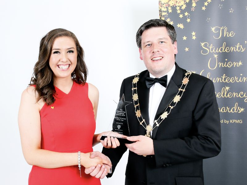 Catriona Henry being presented with the Student Volunteer of the Year Award by Feargus McCauley, Queen’s Graduate Association